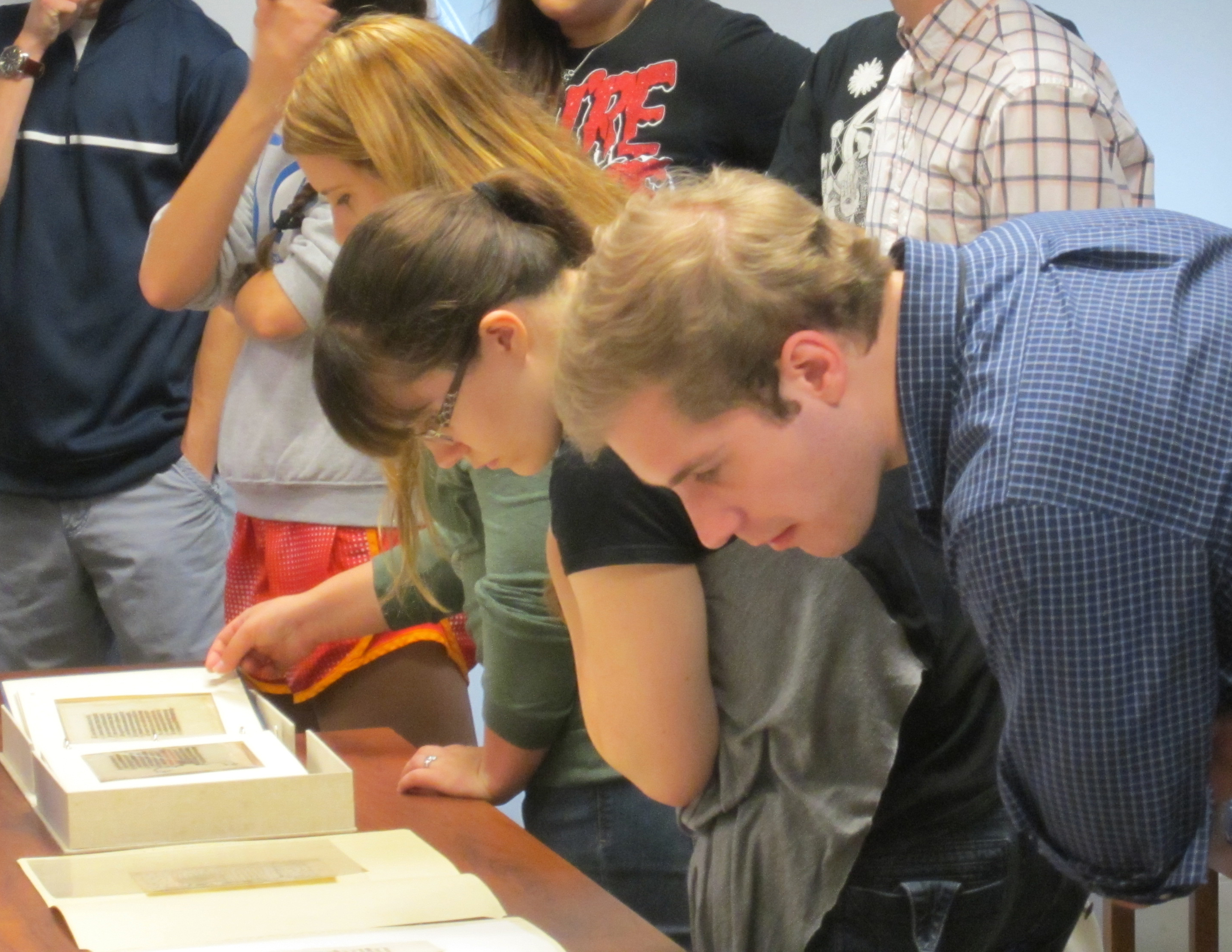 Students take a close look at our medieval manuscripts, featuring the legend of St. Margaret. (Photograph by Petrina Jackson)