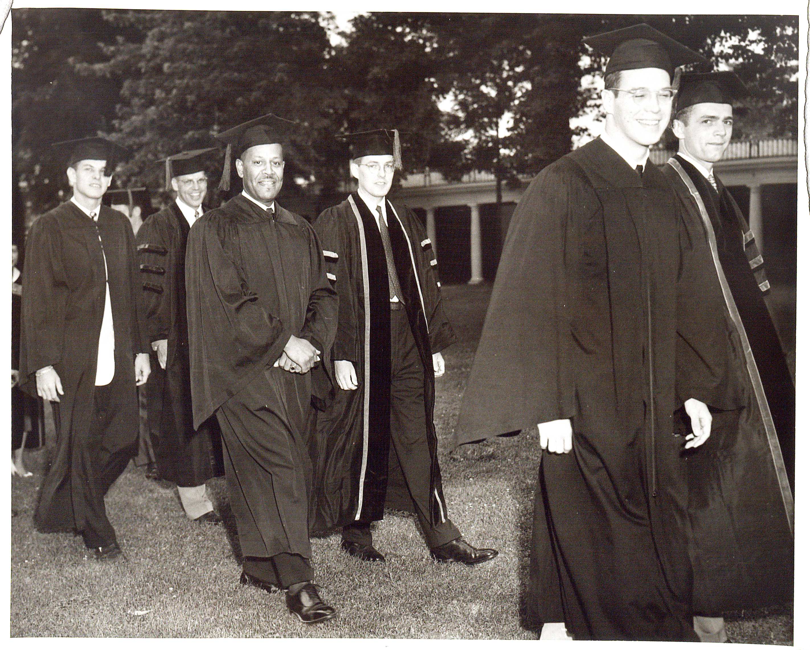 Photograph of UVa Finals, Academic procession. 15 June 1953.  (RG-30/1/10.011) University of Virginia Visual History Collection Here, a photograph of Walter Nathaniel Ridley, the first African American to graduate from the University of Virginia, is captured.  Ridley (center) smiles for a photograph as he walks the Lawn at the Academic Procession of the summer of 1953.  Ridley received a Ph.D. in education.   