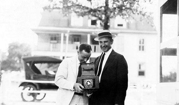Jackson Davis with camera and an unidentified man (MSS3072, 3072a) Jackson Davis Collection of African American Photographs A photograph taken in 1915 illustrates the use of a camera widely available to the general consumer, which was most likely a Kodak. Cameras at the time would have already started using film and shutters to capture an image. Film is able to retain an image because chemically, it is made with a substance that reacts when struck with a light, namely a flash. The camera revolutionized the way events and people are remembered from a sketch or drawing to a photograph capturing every detail. 